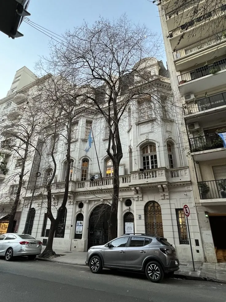 La fachada del edificio donde se realizan los encuentros, con los árboles de la vereda